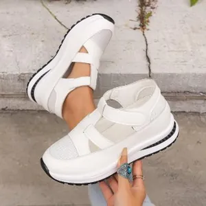 Detail view of white platform wedge sandals featuring breathable mesh and velcro straps