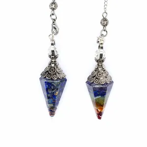 Macro detail showing seven chakra crushed crystals inside resin hexagonal cone pendulums