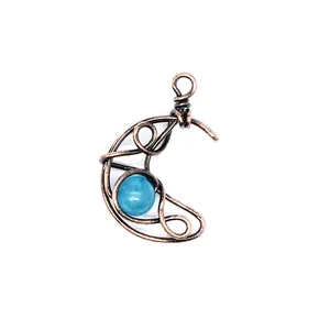 Detailed view of handmade copper wire wrapped crescent moon pendant with blue stone