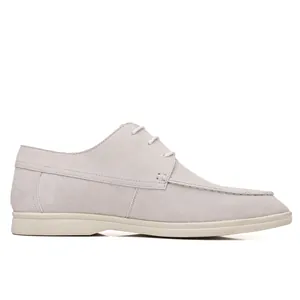 Detailed side profile of off-white suede casual loafer with white laces and sole
