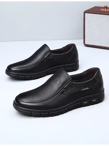 Detailed side view of men's black leather slip-on loafers with durable rubber soles