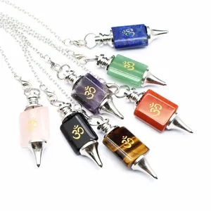 Close-up view of various healing gemstone dowsing pendulums with golden Om symbols.