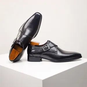 Close-up of elegant black leather monk strap dress shoes with silver buckle detail