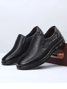 Detail view of premium black genuine cowhide leather loafers with pebbled texture