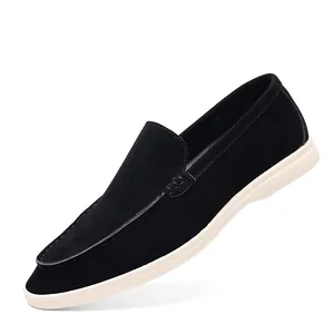 Detailed side view of black suede breathable casual men's loafers with white soles.