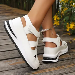 Detailed close-up view of white women's platform wedge sandals with hollow-out design