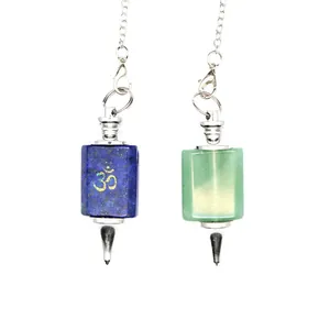 Close-up of Lapis Lazuli and Aventurine crystal pendulums with engraved Om symbol