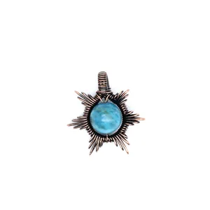 Detailed view of handmade copper wire-wrapped sun pendant with blue natural stone