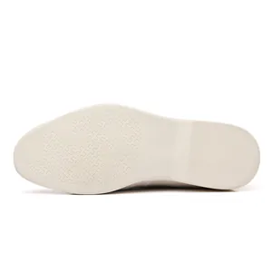 Macro view of the anti-slip textured off-white rubber sole of casual loafers for men and women