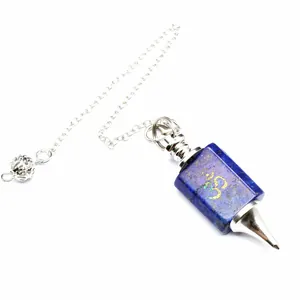 Close-up of lapis lazuli dowsing pendulum with engraved golden Om symbol and silver chain