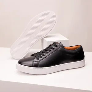 Minimalist black leather men's sneakers featuring a thick white sole and durable laces