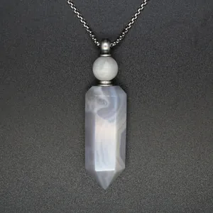 Close-up detail of natural grey agate hexagonal pillar crystal perfume bottle necklace