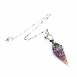 Macro detail view of an amethyst crystal dowsing pendulum with an ornate silver chain