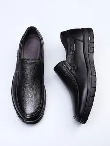 Detailed view of men's black genuine leather slip-on loafers with textured finish