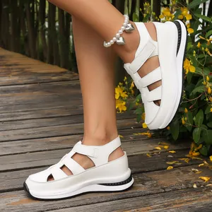 Detailed side view of white hollow wedge sandals with thick soles and velcro straps