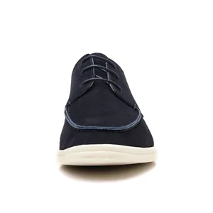 Front view of navy blue suede lace-up loafers with contrasting white rubber sole