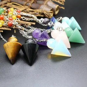 Close-up detail of 7 Chakra crystal arrowhead pendulums for healing and dowsing.