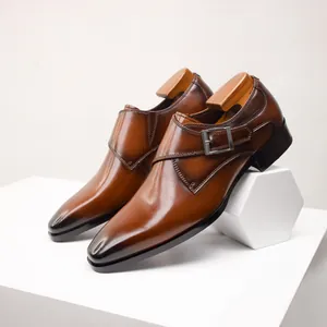 Classic brown leather monk strap dress shoes with elegant metal buckle detail and toe tint