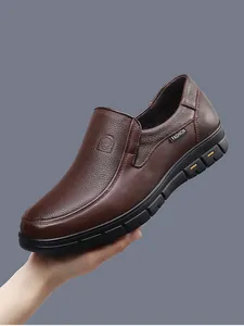 Close-up detail of brown pebble-grain leather men's breathable slip-on loafers