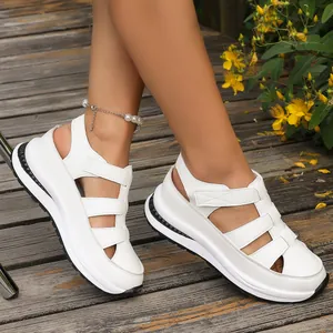 Close-up of white wedge platform sandals with hollow out design and velcro straps
