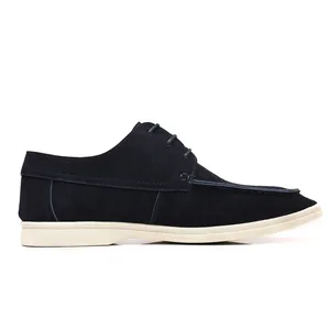 Side profile macro view of men's navy blue suede casual loafers with contrasting white sole