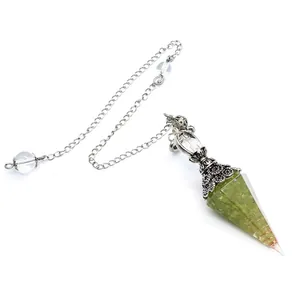 Detailed view of a green resin crystal pendulum with metal coil and silver chain