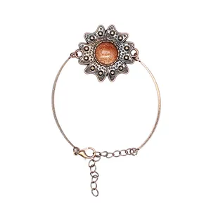 Detailansicht eines Vintage-Blumenarmbands mit schimmerndem Goldstein-Mittelstück