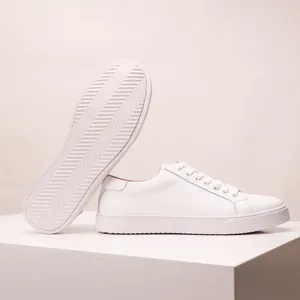 Detail view of premium white leather sneaker featuring anti-slip thick sole and handmade stitching
