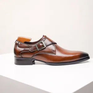 Side detail of a brown leather monk strap shoe with burnished toe and metal buckle.