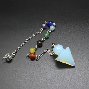 Close-up of white opalite arrowhead crystal pendulum with seven chakra beads.