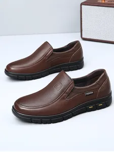 Side view detail of brown genuine leather men's slip-on loafers with textured finish