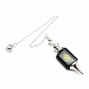 Polished black gemstone dowsing pendulum featuring a gold Om symbol and durable silver chain.