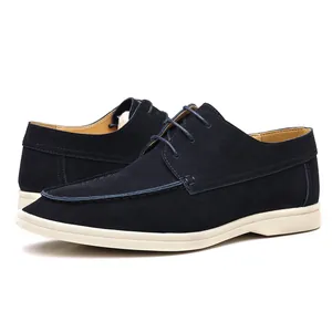 Side detail of navy blue suede lace-up loafers with contrast white soles for men