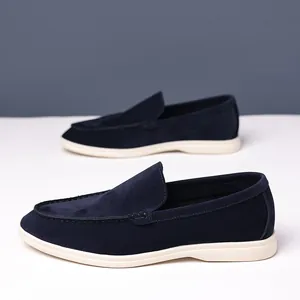Side view of stylish men's navy blue suede loafers with contrast white rubber soles