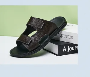 Detailed view of men's dark brown textured leather sandals with non-slip soles for summer