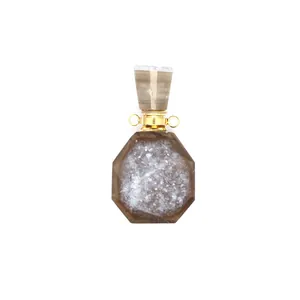 Close-up detail of a natural druzy agate perfume bottle pendant with gold plating