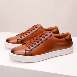 Close-up of premium brown leather sneakers with thick white soles and matching laces.
