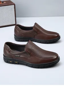 Detail view of brown genuine leather men's loafers with slip-on design and pebbled texture