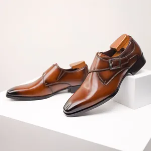 Detailed macro shot of premium brown leather monk strap loafers with elegant metal buckle