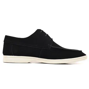 Side profile detail of men's black suede casual loafers with contrast white rubber sole
