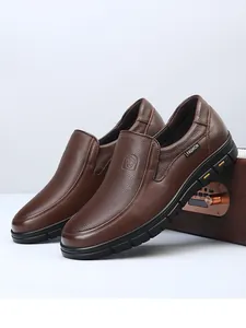 Detailed side view of premium brown leather men's loafers showing grain texture and durable sole