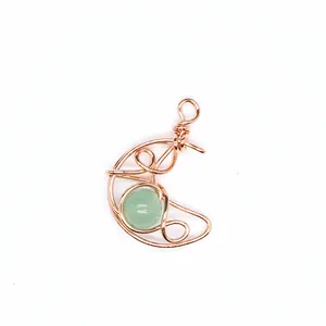 Handmade rose gold wire-wrapped crescent moon pendant with green natural stone detail