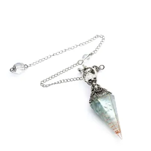 Detailed view of hexagonal cone dowsing pendulum with blue crystal chips and coil