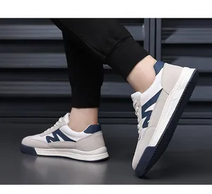 Side detail of men's retro German trainer sneakers with navy blue and beige paneling