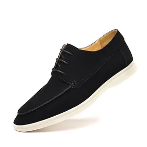 Close-up detail of black suede casual men's shoe featuring white sole and lace-up style