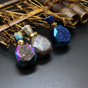 Close-up of three colorful druzy agate perfume bottle pendants on rustic bamboo background