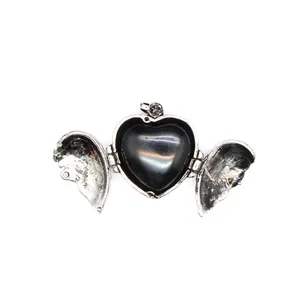 Detail showing openable vintage angel wings heart pendant with black natural stone inlay