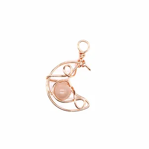 Detailed view of handmade wire-wrapped crescent moon pendant with natural sunstone