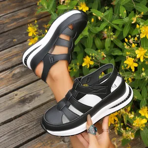 Detailed view of women's black hollow out wedge sandals with thick white platform sole