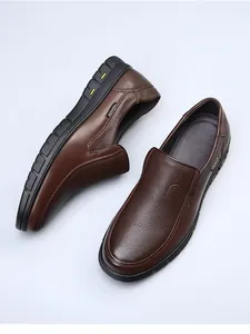 Top-down view of brown genuine leather slip-on loafers with detailed grain texture